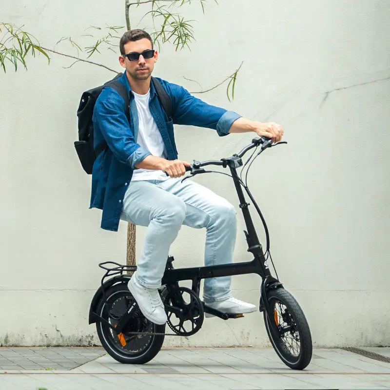 Urban commuter riding a compact folding electric bike through a European city on a morning commute