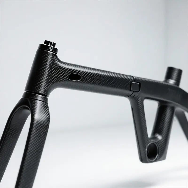 High-resolution photo of RYD Aero 16 carbon fiber frame in a clean production environment showing the visible carbon fiber structure