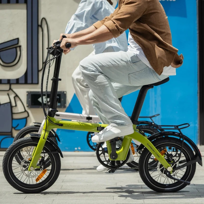 Riding RYD Aero 16 carbon folding electric bikes through a city street