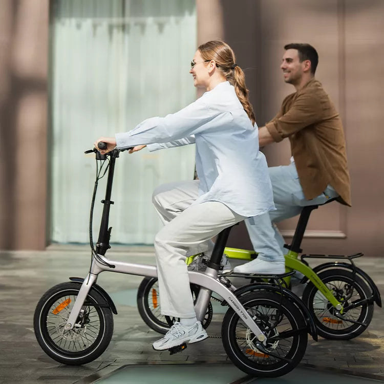 Two people riding RYD Aero 16 premium carbon fiber e-bikes showcasing lightweight design and freedom of urban mobility