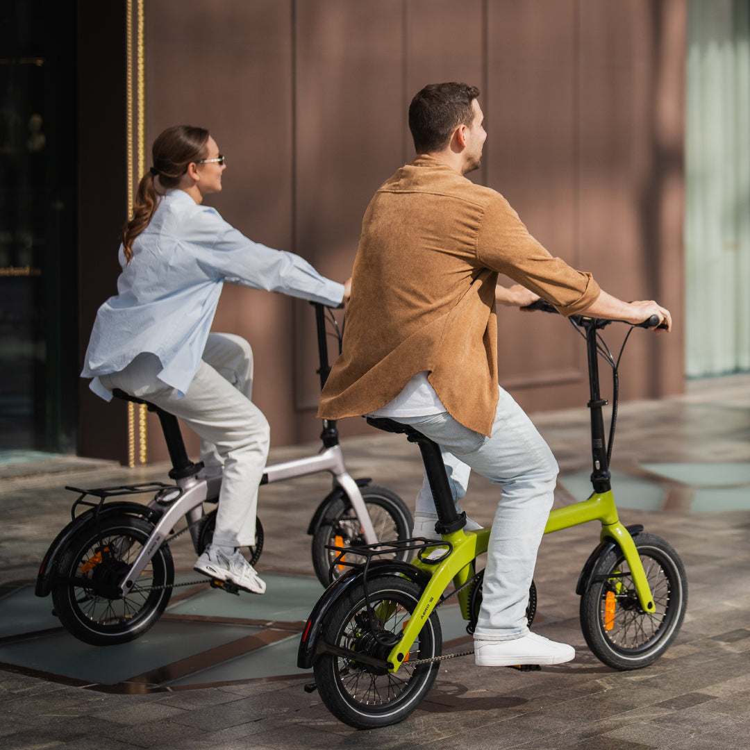Two people riding RYD Aero 16 carbon folding e-bikes featuring responsive torque sensor technology for a natural cycling experience